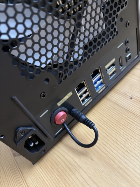 View from the back, with a power plug jutting out.